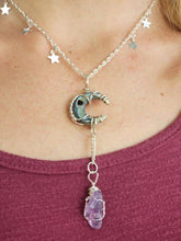 Load image into Gallery viewer, Amethyst crystal hand wrapped in silver wire hanging from wrapped crescent moon shaped abalone shell corresponding chain with stars.  
