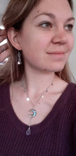 Load image into Gallery viewer, Amethyst crystal hand wrapped in silver wire hanging from wrapped crescent moon shaped abalone shell corresponding chain with stars. Matching amethyst and silver earrings.  
